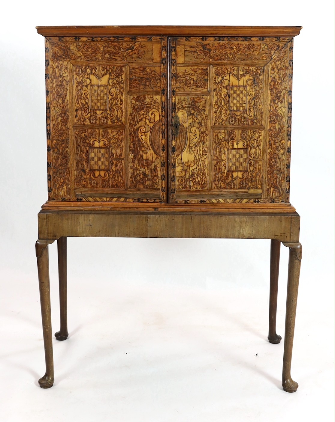 A 17th century and later South German walnut and marquetry cabinet on later stand, width 110cm, depth 53cm, height 153cm